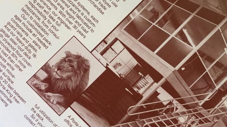 A sepia-toned photo of a lion lying indoors next to a bookshelf and desk, featured on an open magazine page sponsored by Porta-King with visible text.