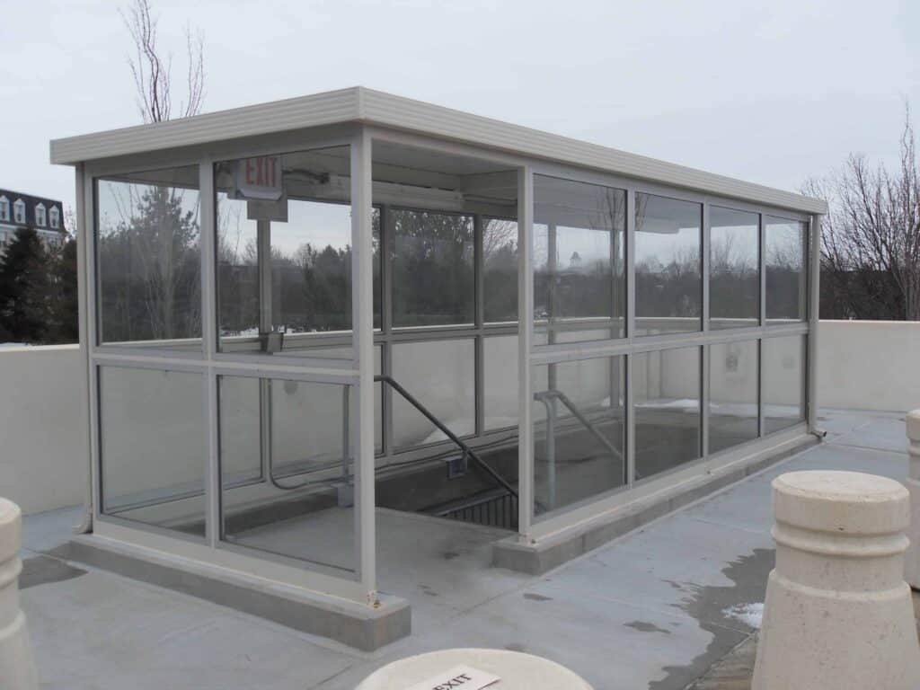Stair well enclosure provides weather protection for patrons of this commercial building