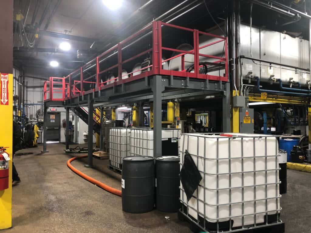 Equipment platform mezzanine with full perimeter custom red colored guard rail