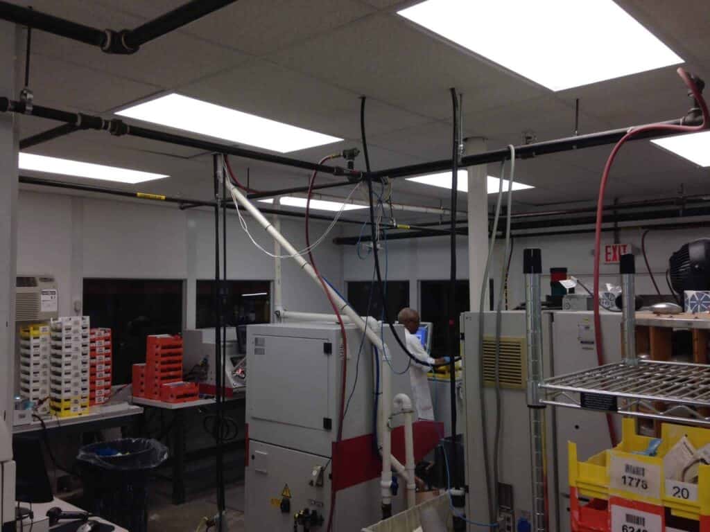 An individual working in a large controlled environmental room