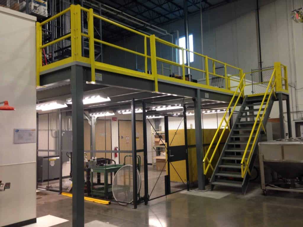 Storage platform mezzanine with safety yellow guard rail and sliding gate