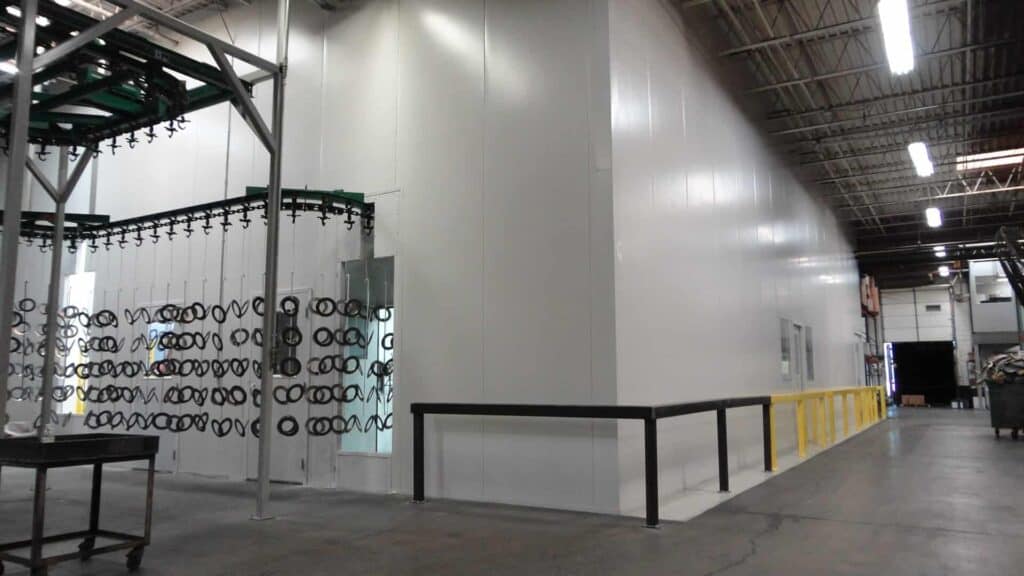 A large controlled environmental room for power paint application