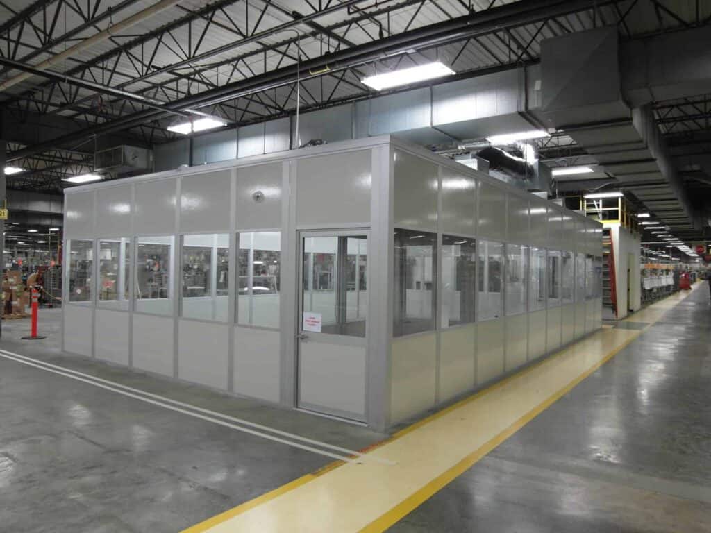 A controlled environmental room with windows in a warehouse