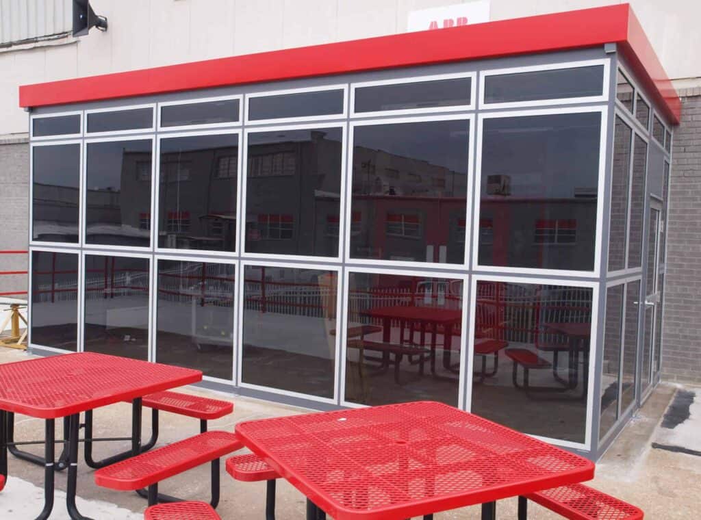 an entry vestibule with a red roof and tinted glazing built by Porta-King