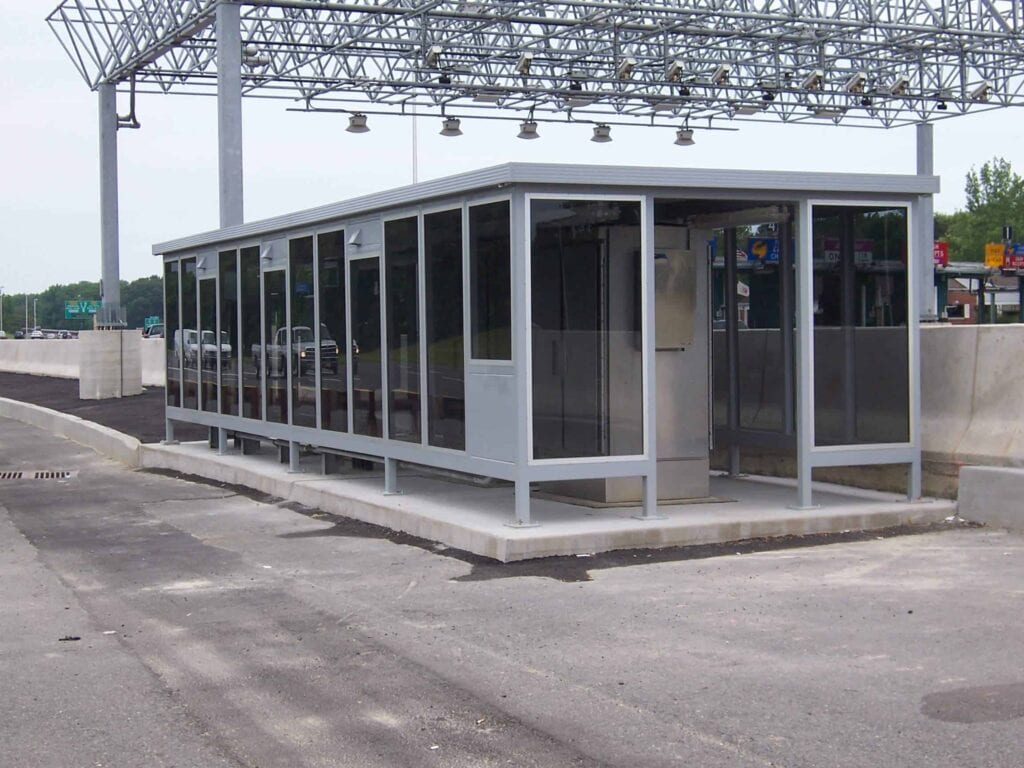 a glass and steel equipment shelter built by Porta-King