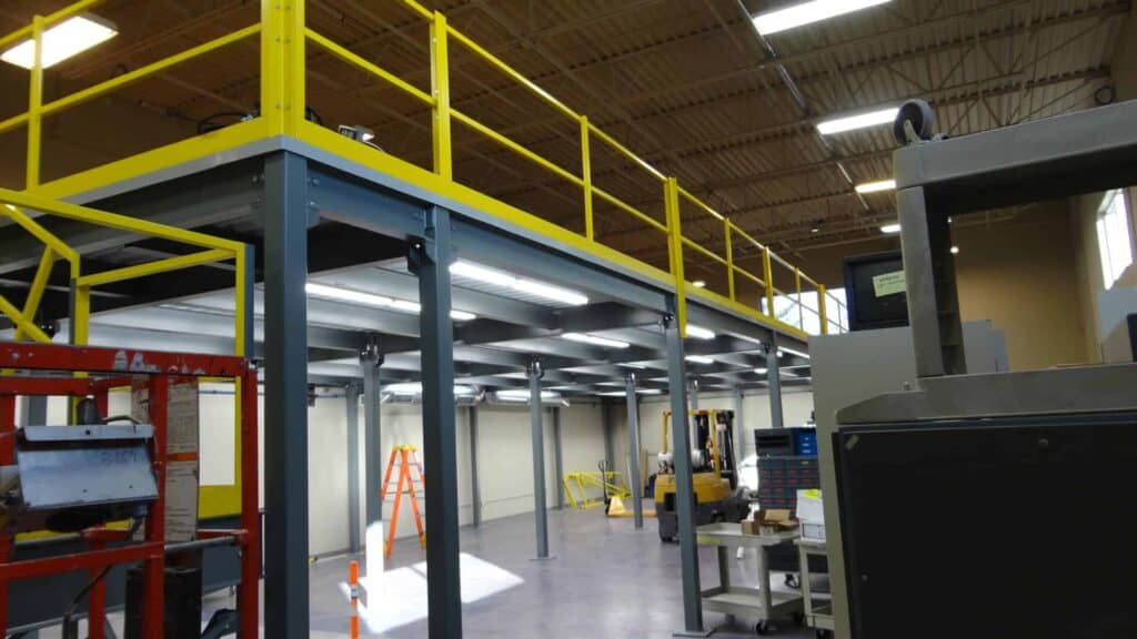 Storage mezzanine with lighting mounted under the floor deck