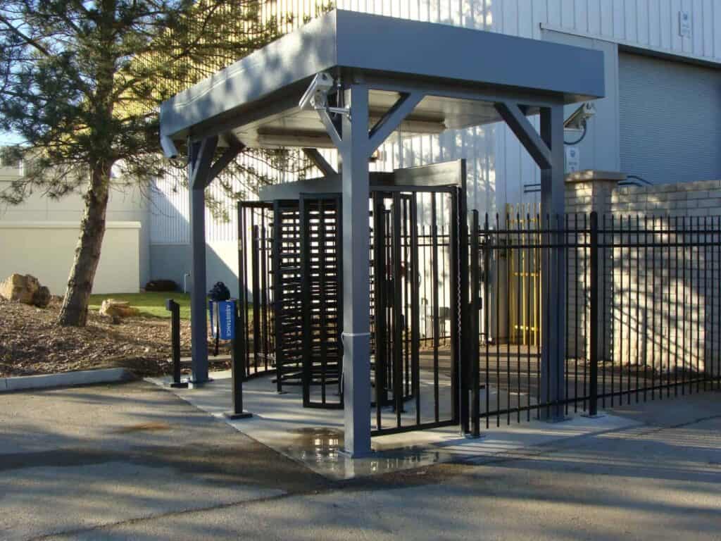 a prefabricated turnstile shelter with a security camera