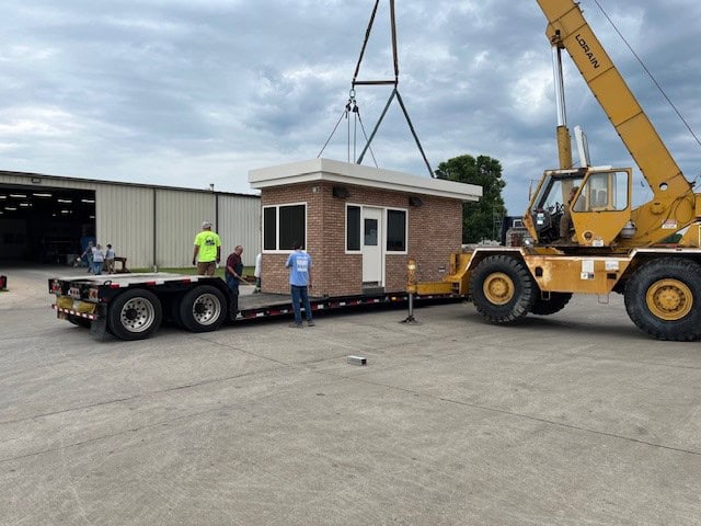 Loading a guard booth with brick exterior